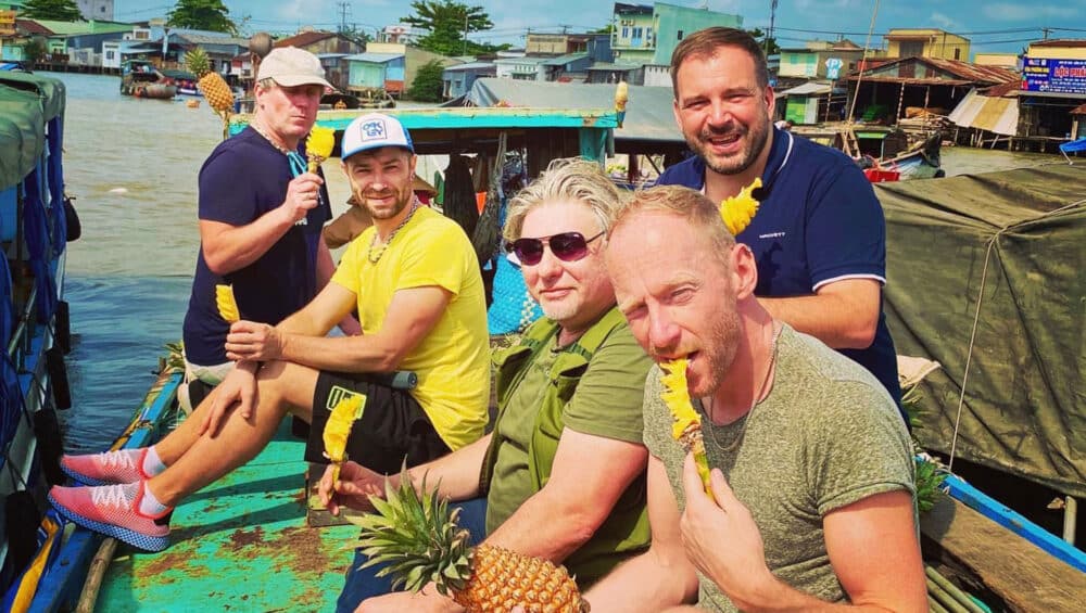 Des touristes qui mangent un ananas au Delta du mékong